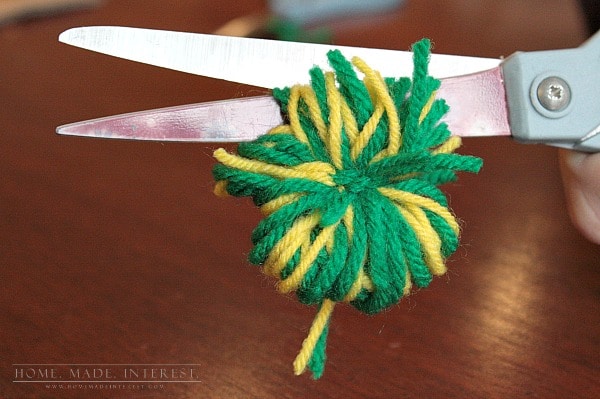 This simple craft tutorial on how to make yarn pom poms will change your life! You’ll want to put yarn pom poms everywhere! They are great for party decorations, garlands and banners, and cupcake toppers! 