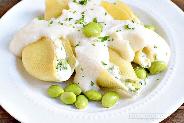 Edamame paired with lemon ricotta cheese is the perfect substitute for meat in these vegetarian stuffed shells with a cauliflower sauce. 