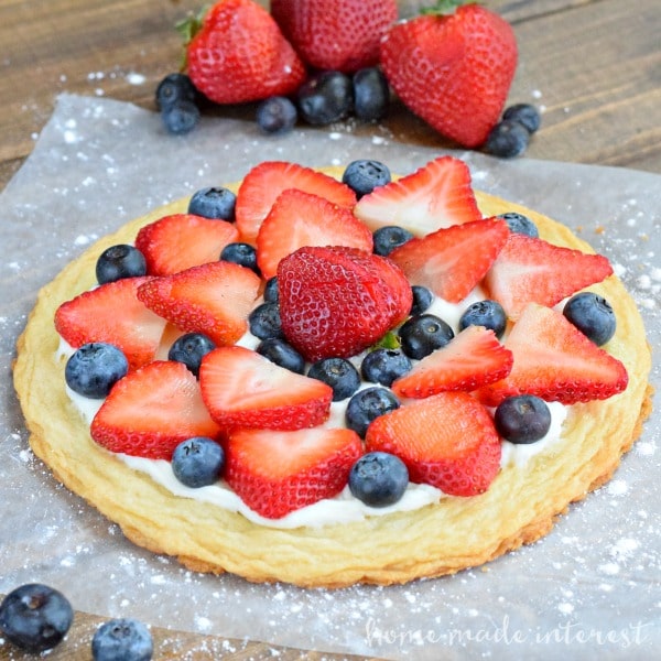 Yum, this summer fruit pizza is perfect for 4th of july, BBQs, picnics, or any summer party! Fresh strawberries and blueberries make this an awesome cookie dessert recipe.
