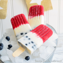These Red White and Blue Popsicles are made fresh summer fruit, raspberries & blueberries, for a delicious, cool dessert for Memorial Day, 4th of July, or Labor Day! Kids and adults will love these all natural, fruit and yogurt popsicles at all of your summer parties.