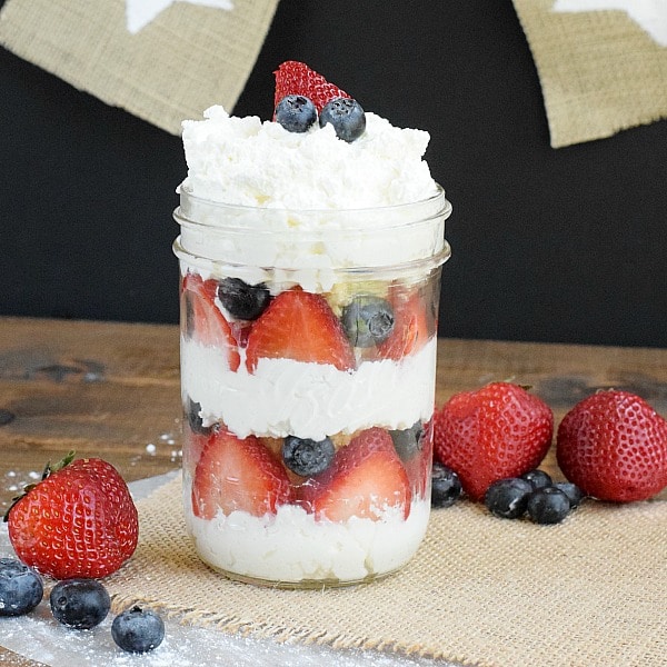 I cherish food in a jar! These cupcakes in a jar are a straightforward Memorial day or 4th of July recipe. Mason jar cakes are huge for picnics or BBQs.  No Bake Crimson White and Blue Cake Red Whte Blue Cupcake in a Jar featured
