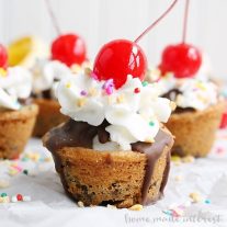 These easy banana split cookie cups are perfect for summer parties...or just a fun dessert for your family! Delicious cookie dough baked into cups and filled with chocolate, banana slices, whipped cream and of course a cherry on top. Who needs a plain old sundae when they could have a banana sundae cookie cup!