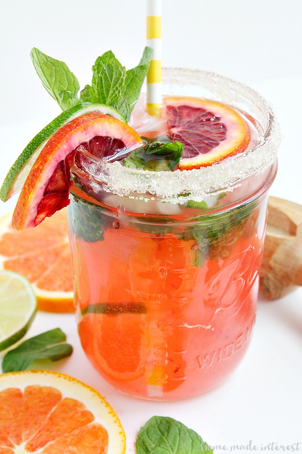 Blood Orange Mojito from the side garnished with oranges