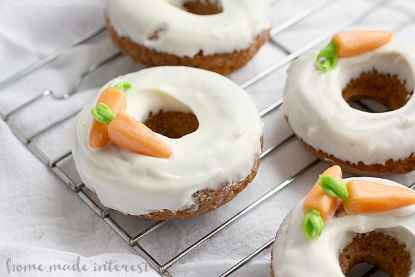 Baked Carrot Cake Donuts | These baked Carrot Cake donuts are frosted with a cream cheese glaze and topped with edible carrots. It is one of the best Easter brunch recipes or Easter dessert recipes. These carrot cake donuts are made with a boxed cake mix and are so easy to make! If you’re looking for a sweet Easter brunch recipe you have to try these.