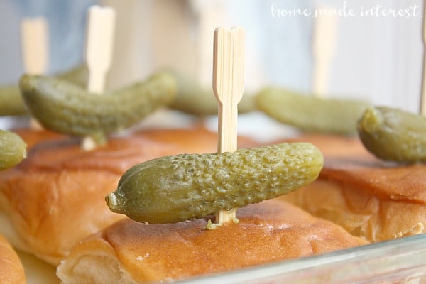 This Cuban sliders recipe is filled with ham, pork, and gooey cheese, all topped with a mini pickle! It is a great slider recipe for parties because you can make them ahead of time and then bake them before your guests arrive. It’s a game day recipe your family and friends will love!