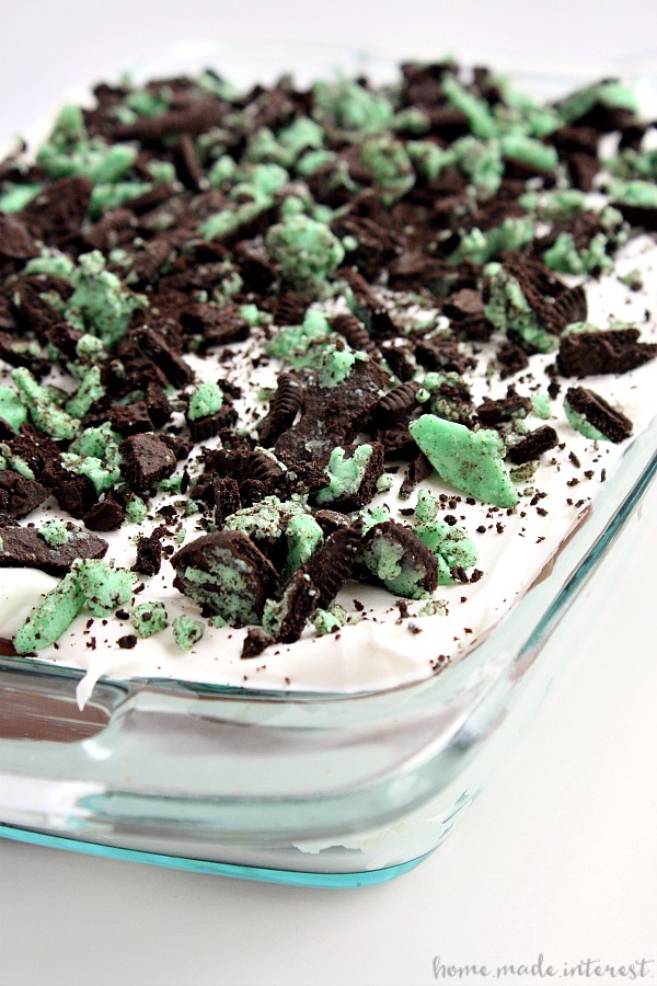 Layers of Mint Oreo, chocolate pudding, cream cheese, and Cool whip make a delicious mint oreo layered dessert that is a fun recipe for St. Patrick’s Day!