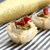 These bite-size appetizers are perfect for parties. Creamy cheese in a phyllo cup, topped with sun dried tomato, pesto.