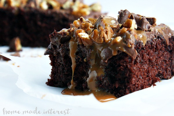 Poke cakes are such an easy cake recipe to make! This Turtle Poke Cake is covered with caramel that seeps into the cake and then topped with creamy chocolate frosting, pecans, and chunks of Turtle candy. This is the perfect easy cake to make for parties!