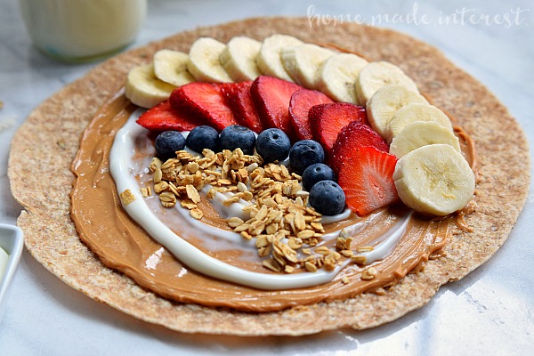 One of the ways I make it through the day is with these easy peanut butter and banana breakfast and snack wraps. You can add any combination of fruits, granola, honey, yogurt, ets to make them into a great breakfast or snack option.