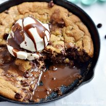 This Peanut butter cup skillet cookie is an easy dessert recipe that your whole family will love. Chocolate Chip cookie dough, peanut butter cups, and chocolate chips are melted together in a mini skillet for a cookie recipe that is a dessert made for two.