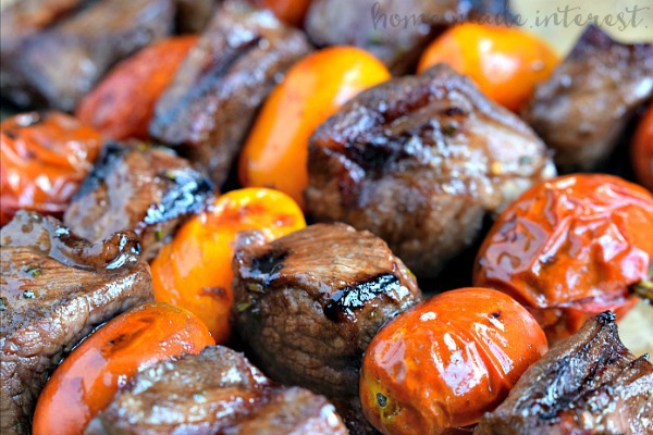These Rosemary Steak Skewers taste as good as they look! Angus steak is marinated in a balsamic glaze and then skewered on a piece of rosemary with cherry tomatoes. This easy grilled steak recipe is perfect for cooking out on Father’s Day and it makes a great summer grill recipe to share with friends and family.