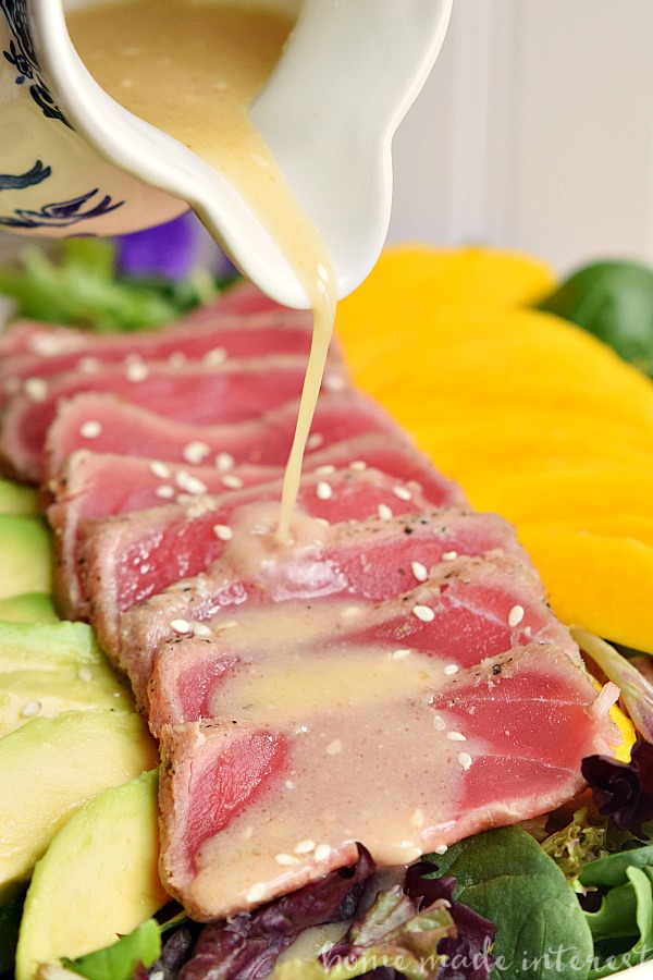 This light and fresh seared tuna salad is a healthy lunch option mixed with mangoes and avocados and topped with a Miso vinaigrette.