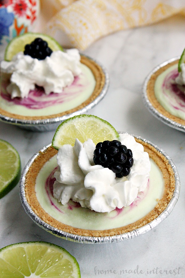 Nothing says summer like blackberries and lime. This easy no bake pie recipe is going to make a great snack for the kids or summer dessert for the family. Fresh blackberries, lime yogurt, and whipped cream in a mini graham cracker pie crust make this frozen summer dessert easy and delicious!