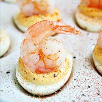 Shrimp cocktail deviled eggs are a new twist on two retro classics. This simple appetizer combines shrimp cocktail and deviled eggs for an updated vintage appetizer recipe that is perfect for retro parties!