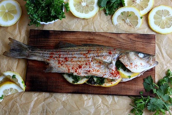 Cedar Plank Grilled Fish is a grilled whole fish full of flavor. This is an easy fish recipe with a lightly seasoned fish grilled on a cedar plank over and open flame. The result is a smokey flavor that will have everyone asking for seconds. Try this easy grilled seafood recipe the next time you fire up the grill.