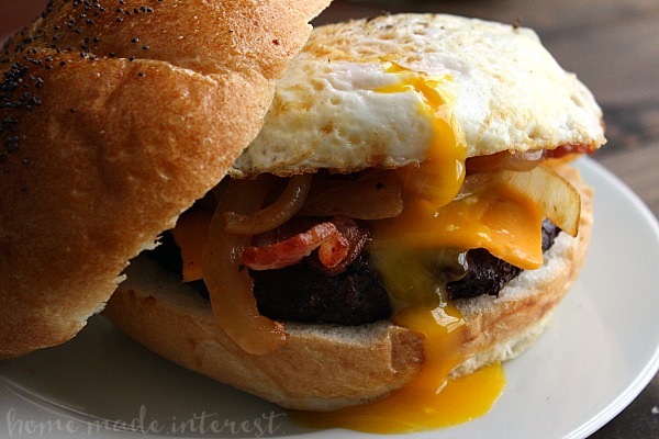 This grilled Bacon BBQ Meatloaf Burger is a tender and juicy burger twist on a classic comfort food, meatloaf! The burger patties are made with a delicious meatloaf base basted in BBQ sauce and topped with crispy bacon and a fried egg! An awesome grilled burger recipe that is perfect for summer, 4th of July, and Labor Day cookouts!