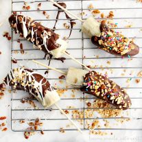Frozen Chocolate Covered Bananas were always one of my favorite after school snacks and now my kids love this easy snack just as much as I do! This Frozen Chocolate Covered Bananas recipe is easy to make and your kids can have fun sprinkling them with their favorite toppings. Then freeze them for a frozen banana snack!