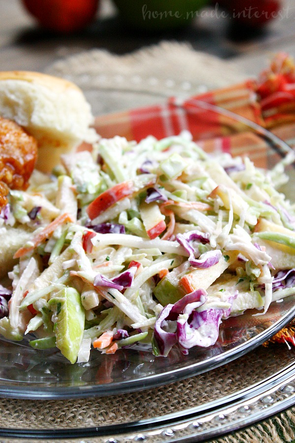 This fall coleslaw recipe is made with crisp fall apples for a sweet fall flavor that is perfect for tailgating, game day parties, and as a Thanksgiving side dish recipe. I like to add some to my honey BBQ sliders to add a little crunch or I just serve it as a fall side dish recipe to eat with hot dogs and burgers.