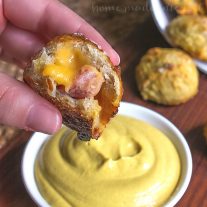These ham and cheese pretzel bombs are pretzel dough stuffed with cheese and delicious ham. They are an easy appetizer recipe that is a great way to use leftover ham. Ham and cheese pretzel bombs are an easy game day appetizer that are exploding with cheesy goodness!