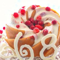 A white chocolate cranberry cake made in a gorgeous heritage bundt pan. This white chocolate cranberry cake is a quick and easy cake recipe made from boxed cake mix. Add in a few extra ingredients and you have a super moist and delicious cake!