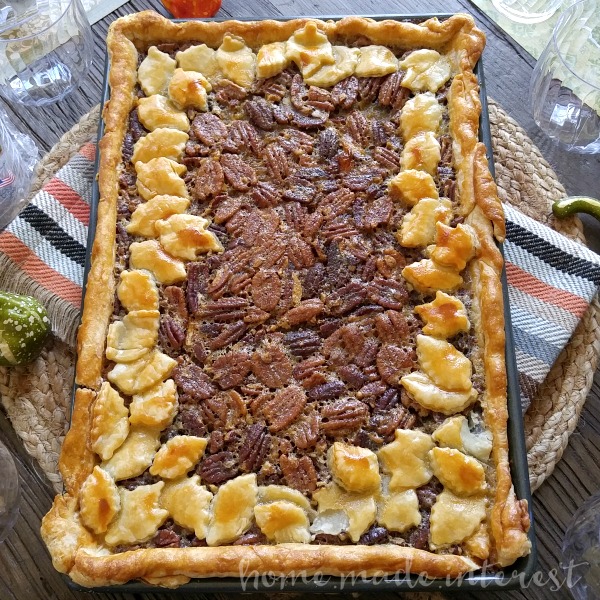 This beautiful pecan slab pie recipe takes a traditional pecan pie recipe and doubles it, making one big slab pie that the whole family will enjoy. Make this pecan slab pie for Thanksgiving dessert or Christmas dessert. This pecan slab pie is extra pretty with a crust made with pie dough cut into fall leaves. Impress your guests with this easy pecan pie recipe!