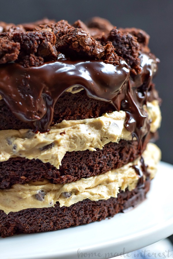 Brownie Chocolate Chip Cookie Dough Cake | This decadent Brownie Chocolate Chip Cookie Dough Cake is made from brownie cake layers filled with no bake chocolate chip cookie dough and topped with a rich dark chocolate ganache glaze. This is a chocolate dessert recipe that you don’t want to miss! Make this easy cake recipe for the chocolate lover in your life!