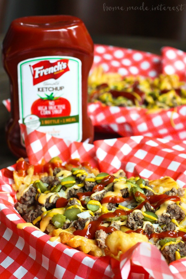 Loaded Cheeseburger Fries | These french fries are loaded with everything it takes to make a great cheeseburger. Ground beef, onions, pickles, cheese, and of course ketchup and mustard. Loaded Cheeseburger Fries are an awesome game day appetizer recipe for your next football party or a weeknight meal for the family. This loaded french fry recipe is going to blow your mind!