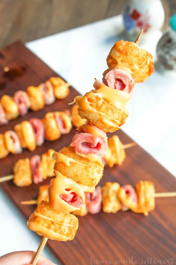 Ham and Cheese Tater Tot Skewers | If you are looking for a simple but totally awesome Game Day appetizer this game day recipe is it. Ham and Cheese Tater Tot Skewers are an easy appetizer recipe with layers of ham and tater tots skewered together and drizzled with creamy american cheese. This is going to be perfect food for your next super bowl party or football party!