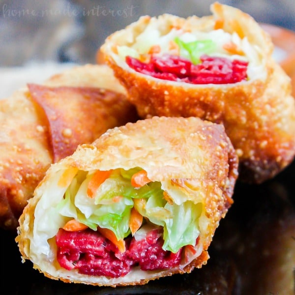 Corned Beef and Cabbage Egg Rolls | Corned beef and cabbage is a classic St. Patrick’s Day recipe. We’ve turned this Irish recipe into an awesome St. Patrick’s Day appetizer. Corned Beef and Cabbage Egg Rolls are all of the classic corned beef and cabbage flavors wrapped up in a crunchy egg rolls and dipped in a creamy parsley sauce. This is an easy St. Patrick’s Day appetizer recipe you don’t want to miss.