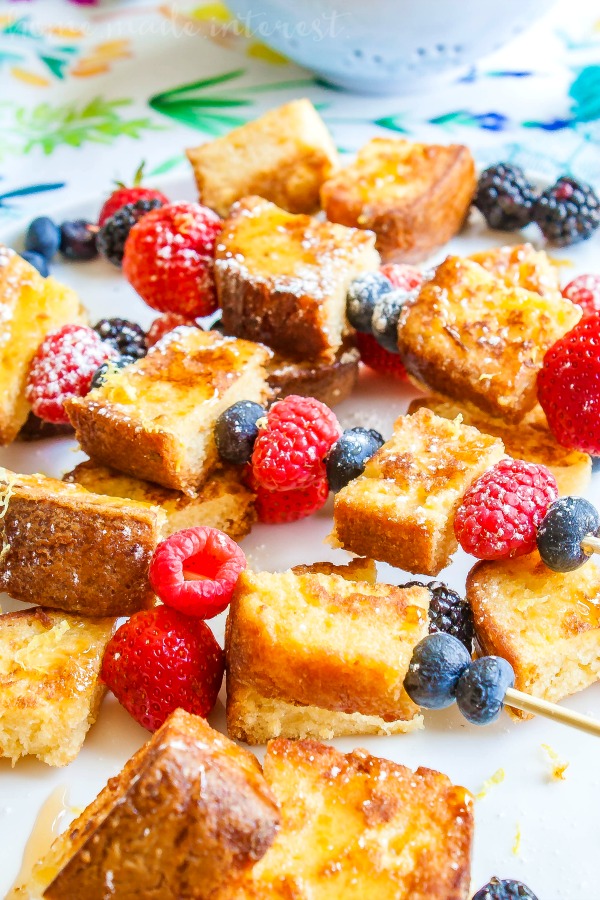 Lemon pound cake french toast with fresh raspberries and blueberries drizzled with syrup