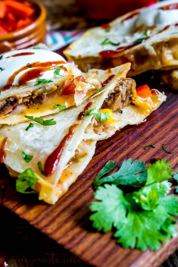 BBQ Pork Quesadillas | This easy quesadilla recipe is oozing cheese and filled with BBQ pork! This is a quick and easy dinner recipe for busy weeknights and a great lunch idea for kids when they are home all summer. These BBQ Pork Quesadillas are an awesome spin on my favorite Tex-Mex recipe! 
