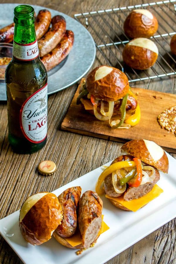 Beer Brat Sliders | If you’re looking for the best grill recipe I’ve got your covered. These Beef Brat Sliders are the best summer party food and they are an amazing way to use grilled bratwurst all summer long. These brats are infused with beer and served on a pretzel bun with beer braised onions and cheddar cheese. This is an easy slider recipe that is perfect for game day parties and makes great football party food. 
