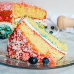 Red, White, and Blue Zinger Cake | This patriotic cake is the BEST 4th of July dessert recipe, Memorial Day dessert recipe, or Labor Day dessert recipe. This easy Red, White, and Blue Zinger cake is covered in shredded coconut and filled with a marshmallow cream to make a beautiful red, white, and blue dessert for the 4th of July!