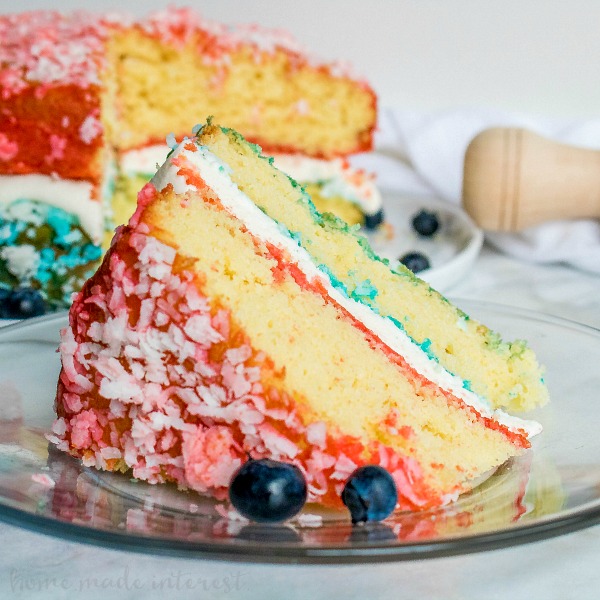 Crimson, White, and Blue Zinger Cake | This patriotic cake is the BEST 4th of July dessert recipe, Memorial Day dessert recipe, or Labor Day dessert recipe. This straightforward Crimson, White, and Blue Zinger cake is roofed in shredded coconut and stuffed with a marshmallow cream to manufacture an ravishing crimson, white, and blue dessert for the 4th of July!  No Bake Crimson White and Blue Cake Red White Blue Zinger Cake featured