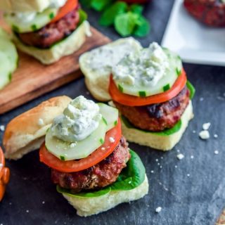 Greek Sliders | These easy Greek Sliders make an awesome appetizer recipe for parties. Make this football party food when you watch the game or serve them as an easy appetizer recipe at a cookout. These grilled Greek sliders are grilled burgers topped with homemade tzatziki to make a delicious slider!