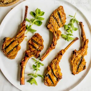 Tandoori Grilled Lamb Chops | This easy lamb chop recipe is a perfect summer grilling recipe. Tandoori-style lamb chops marinated in a tandoori yogurt and spice marinade then grilled on a Big Green Egg. We should you how to use a Big Green Egg to grill lamb chops with lots of flavor. If you love a good Indian food recipe these Indian-inspired grilled lamb chops are for you.