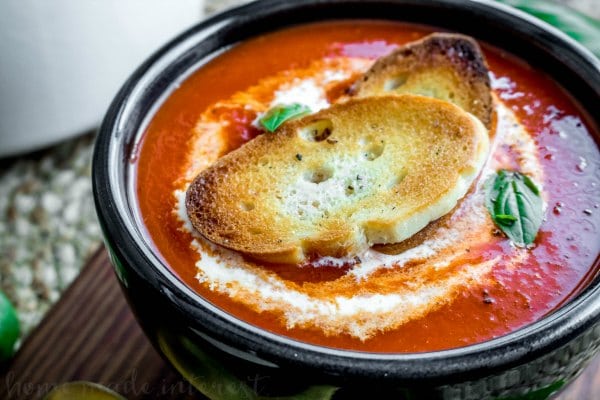 Fire roasted Red Pepper soup with a drizzle of cream and toasted baguettes slices