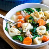 soup of homemade chicken tortellini soup with carrots and spinach