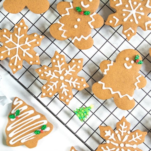 Soft gingerbread cookie recipe with gingerbread men, gingerbread women, Christmas trees, and snowflakes baked and iced with royal icing