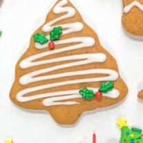 gingerbread Christmas tree cookie with white icing and holly