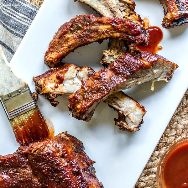 Slow cooker BBQ ribs with sauce and brush