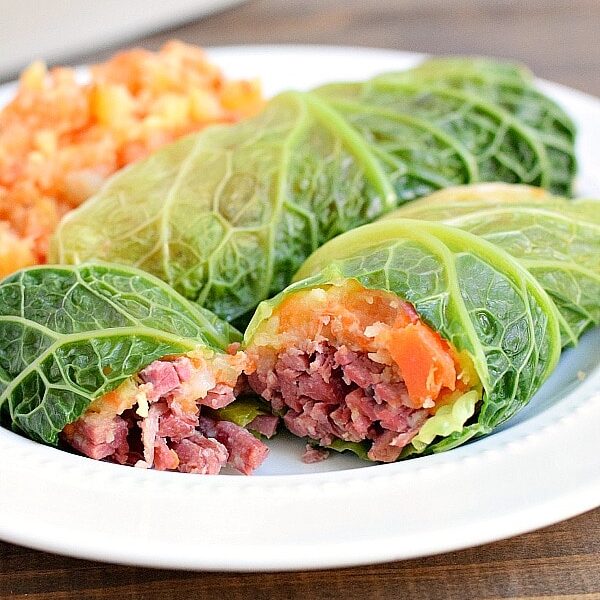 Two corned beef cabbage rolls on a plate