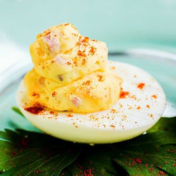 Mississippi Sin deviled egg filled with ham and cheese garnished with paprika