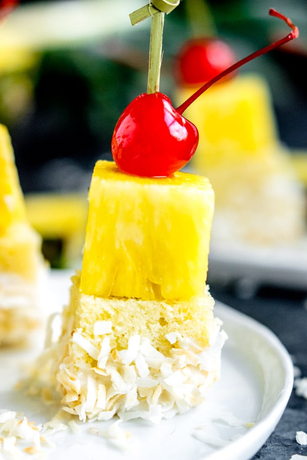 Pina Colada Cake Bite topped with a cherry
