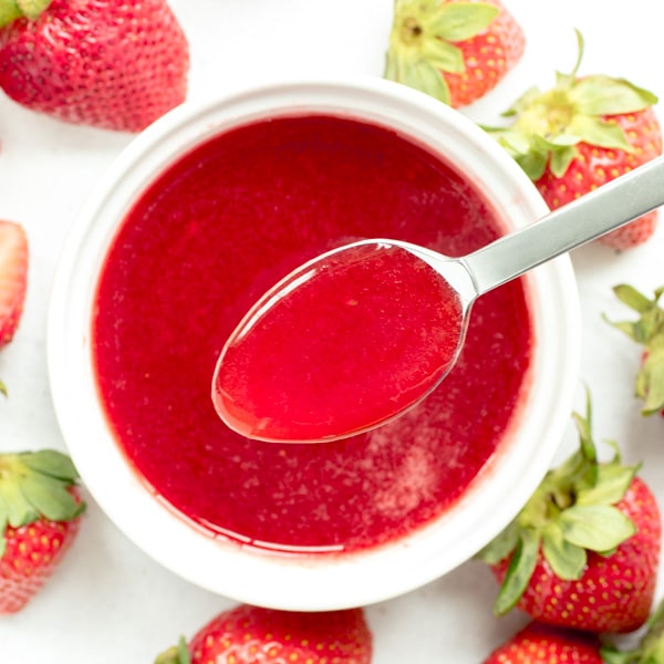 Strawberry Sauce with spoon and white bowl