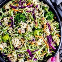 A colorful bowl of asian-inspired ramen noodle salad with mixed vegetables.
