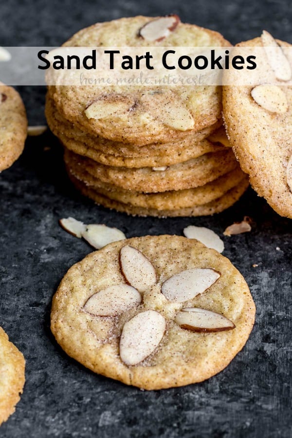 Sand Tarts are thin, crisp, buttery, cinnamon sugar cookies with almond slices on top. This Sand Tart recipe is a Pennsylvania Dutch, or Amish cookie recipe your whole family will love. Make this classic christmas cookie recipe for the holidays and share with friends and family. #cookies #christmascookies #cinnamon #baking #sweettreats #homemadeinterest