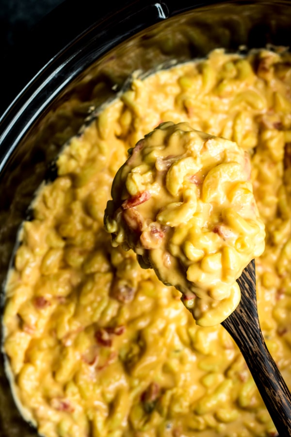 wooden spoon of Spicy Crock Pot Macaroni and Cheese