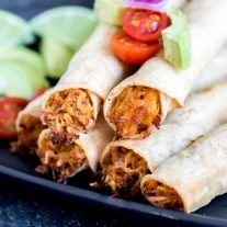 Chicken Taquitos stacked on plate