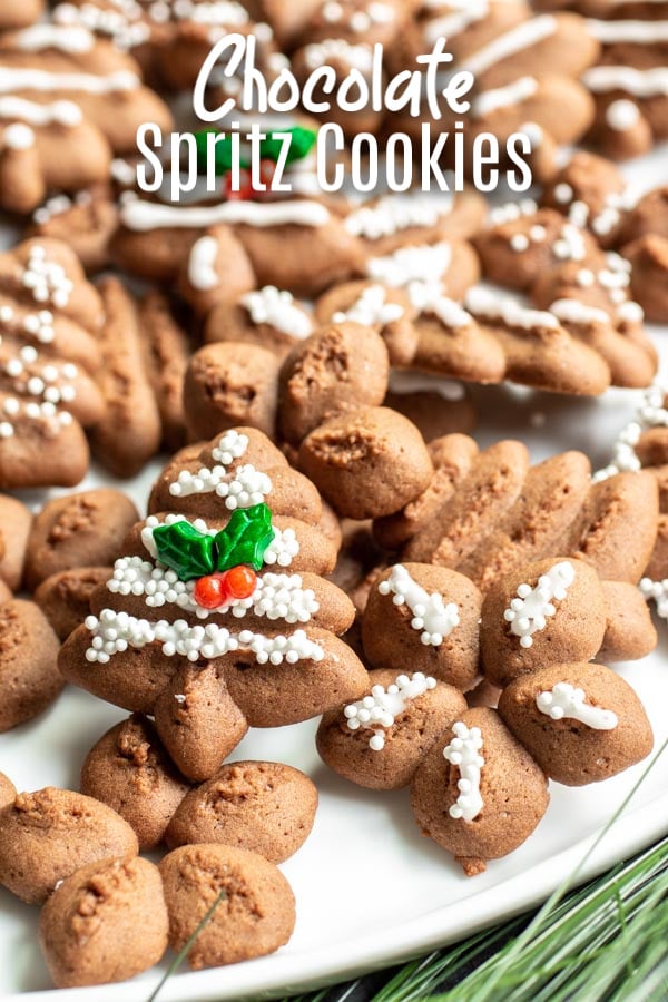 These are the BEST Chocolate Spritz Cookies and one of my favorite Christmas cookie recipes. These buttery spritz cookies are made with cocoa powder for a chocolate flavor and pressed through a cookie press to make delicate cookies decorated with royal icing. They are a classic Christmas cookie recipe that is perfect for the holidays. #christmas #cookies #chocolate #christmascookies #cookieexchange #homemadeinterest